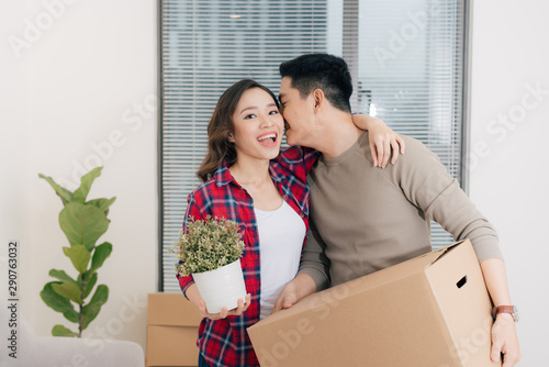 Young asian couple moving to a new apartment together relocation © makistock