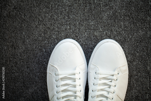 Pair of new stylish white sneakers on floor at home © Maksymiv Iurii