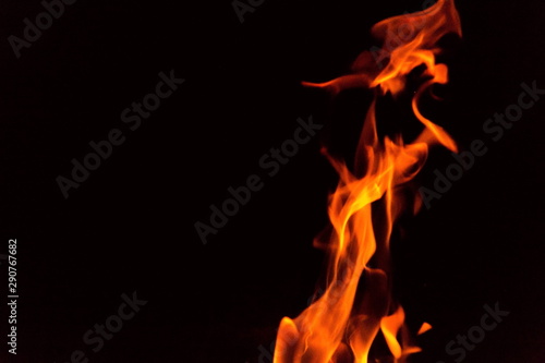 Red and orange fire flames isolated on black background, spooky shapes, large copy space