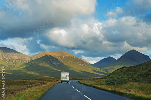 Принти на полотні White campevan driving on th left side of the road in Scotland