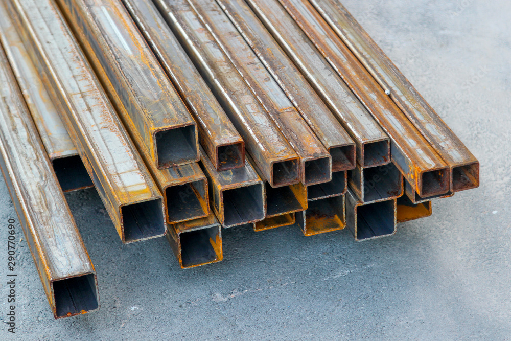 Pile of structural steel square tubes on the ground Pile of structural steel square tubes on the ground