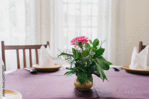 Beautiful flowers in vase on table in restaurant.