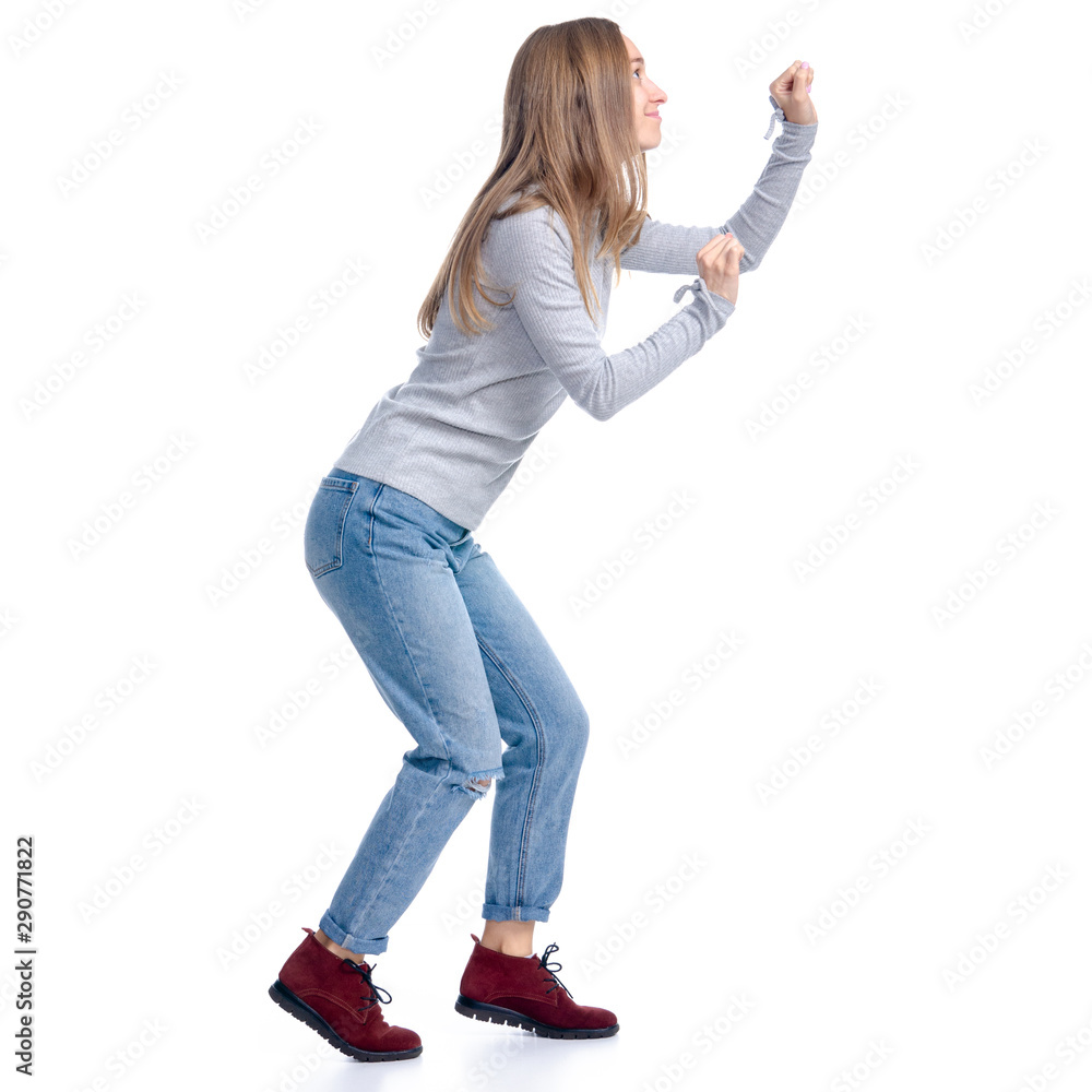 Woman in jeans and gray shirt smiling walking goes sneaks tip toe on white background isolation Woman in jeans and gray shirt smiling walking goes sneaks tip toe on white background isolation