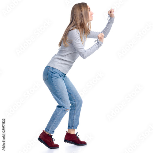 Woman in jeans and gray shirt smiling walking goes sneaks tip toe on white background isolation