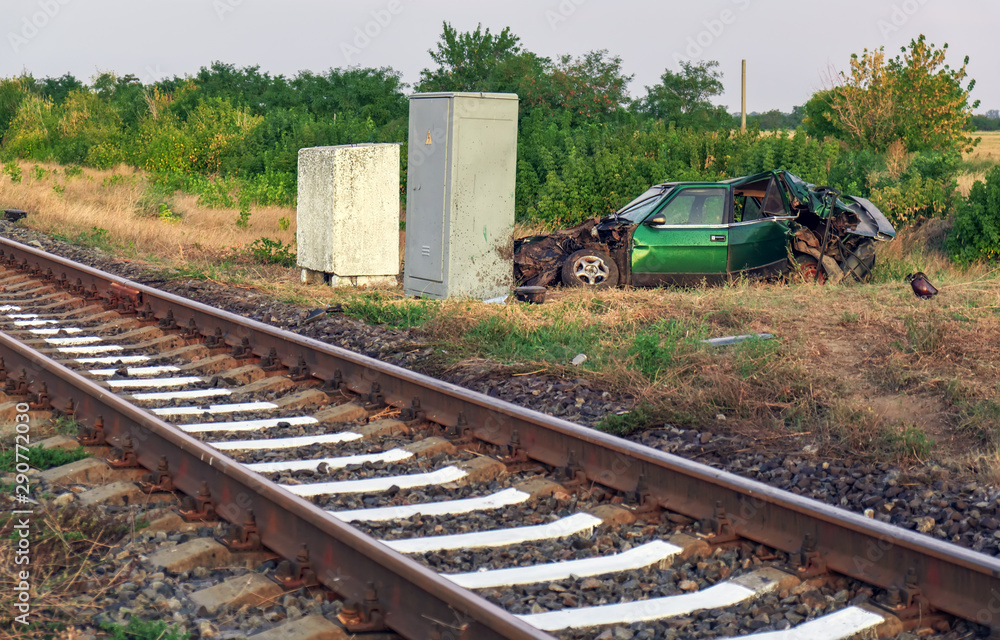 The car had an accident at a railway crossing. Passenger car collided with a train.