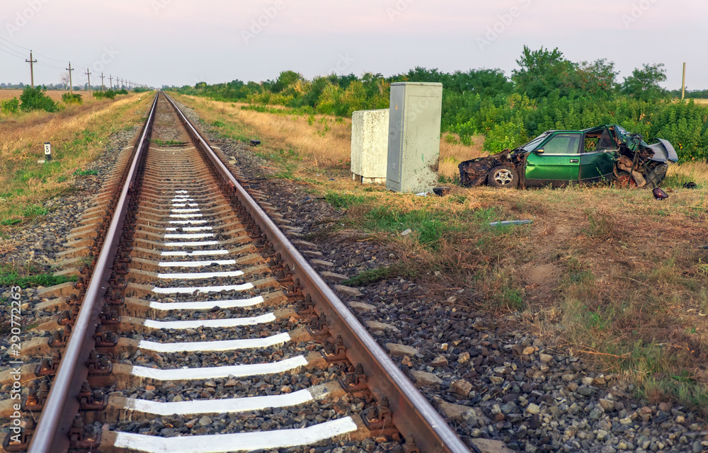 Obraz premium The car had an accident at a railway crossing. Passenger car collided with a train.