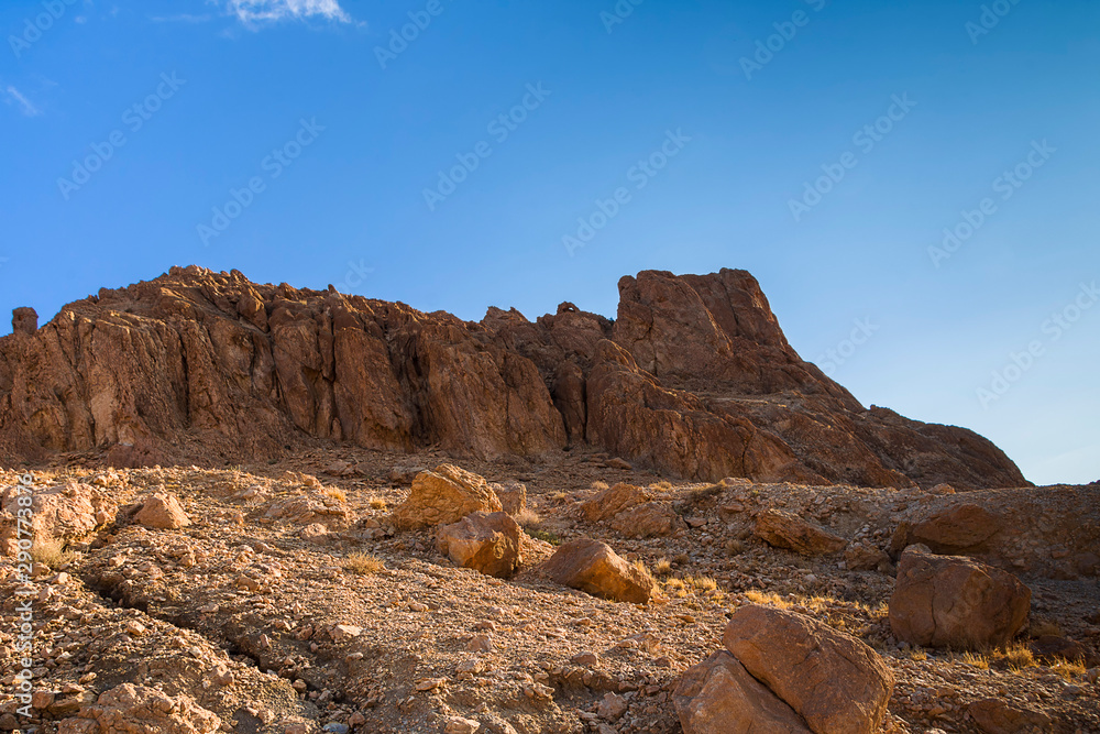 Fototapeta premium Rocky desert peaks of the Atlas mountains in the late morning
