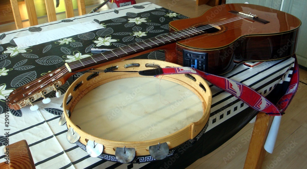 classical guitar and tammorra on the table classical guitar and tammorra on the table