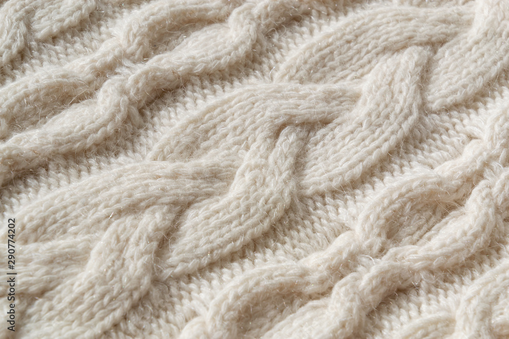 The closeup texture of cashmere things. Macro shot of knitted fabric from Lana Wool threads. Warm winter clothes. Background textile surface with copy space for text. The closeup texture of cashmere things. Macro shot of knitted fabric from Lana Wool threads. Warm winter clothes. Background textile surface with copy space for text.