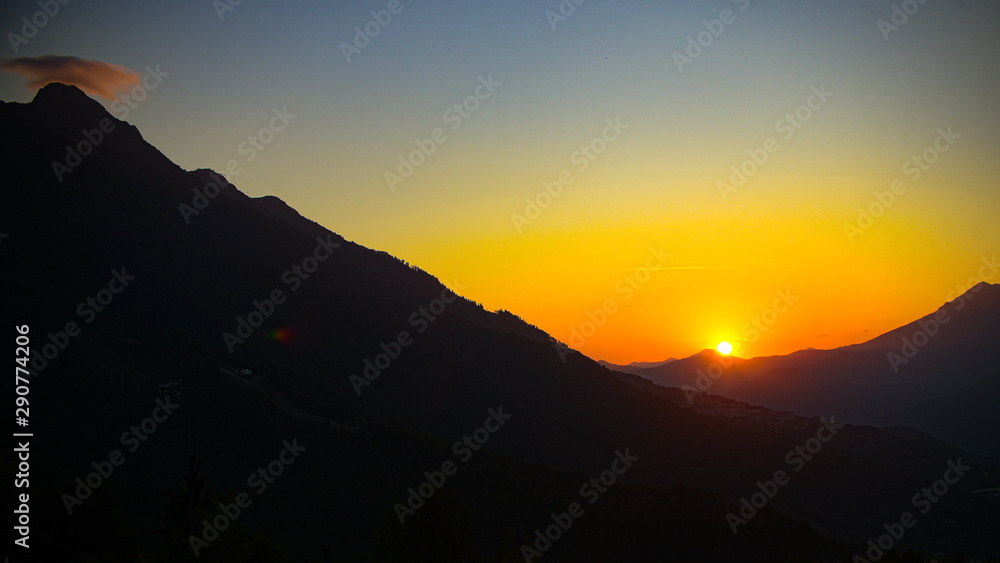 Fototapeta premium Sunset mountain valley hills landscape. Mountain valley sunset panorama.