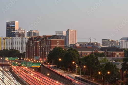 Downtown Atlanta highway with traffic light trails during sunset
