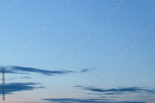 Evening deep blue sky after sunset. Evening colorful background. Twilight cloudy sky.