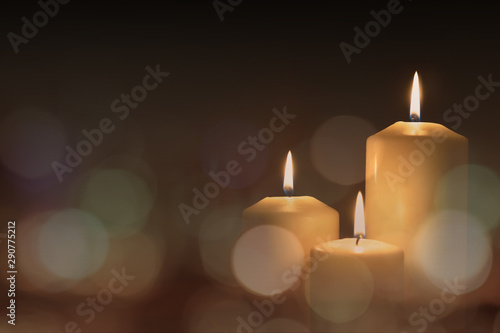 Canvas Print Christmas advent candle light in church with blurry golden bokeh for religious r