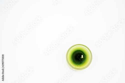 Green candle in clear glass isolated background