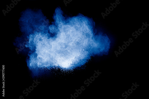 Blue color dust particles splash on black background.Color powder explosion.