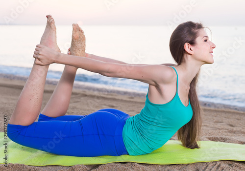Woman in blue T-shirt is practicing stretching