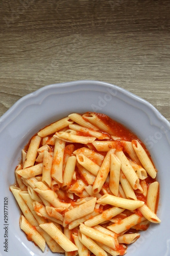 Plate of pasta with homemade tomato sauce. Flat lay.