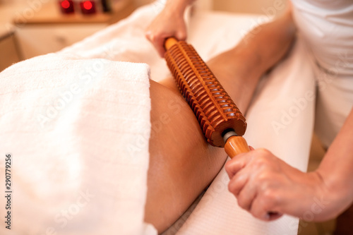 Wooden instruments in maderotherapy applied on the thigh area photo