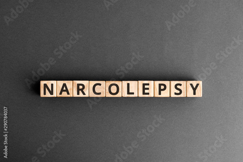 Narcolepsy - word from wooden blocks with letters, sudden falling asleep narcolepsy concept, top view on grey background