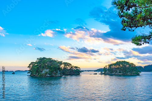 Matsushima Bay in dusk, beautiful islands covered with pine trees and rocks. One of the Three Views of Japan, and is also the site of the Zuigan-ji, Entsu-in and Kanrantei. in Miyagi Prefecture, Japan photo