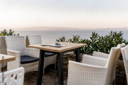 wicker chairs and tables in a summer cafe with sea views. Restaurant sea terrace