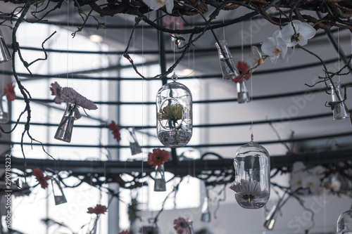 Selective focus Gerbera daisy flowers in glass bottles hang on the air.Home decoration concept.