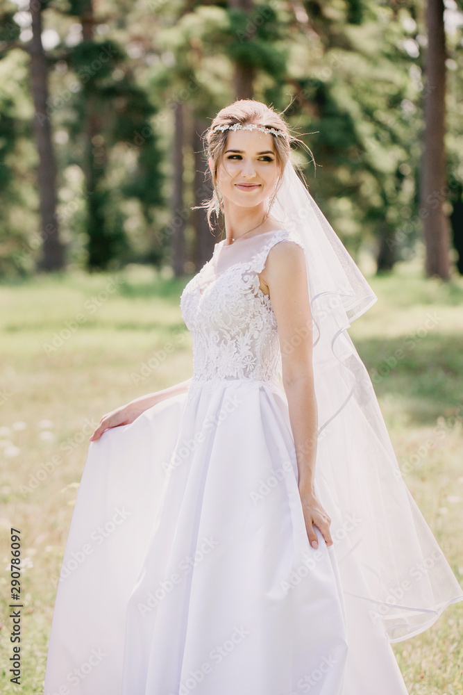 The bride walks in the meadow, close-up
