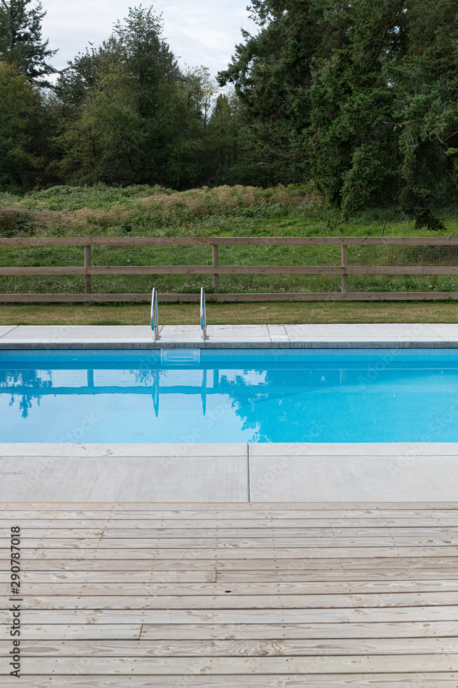 Suburban square swimming pool shot on a cloudy day