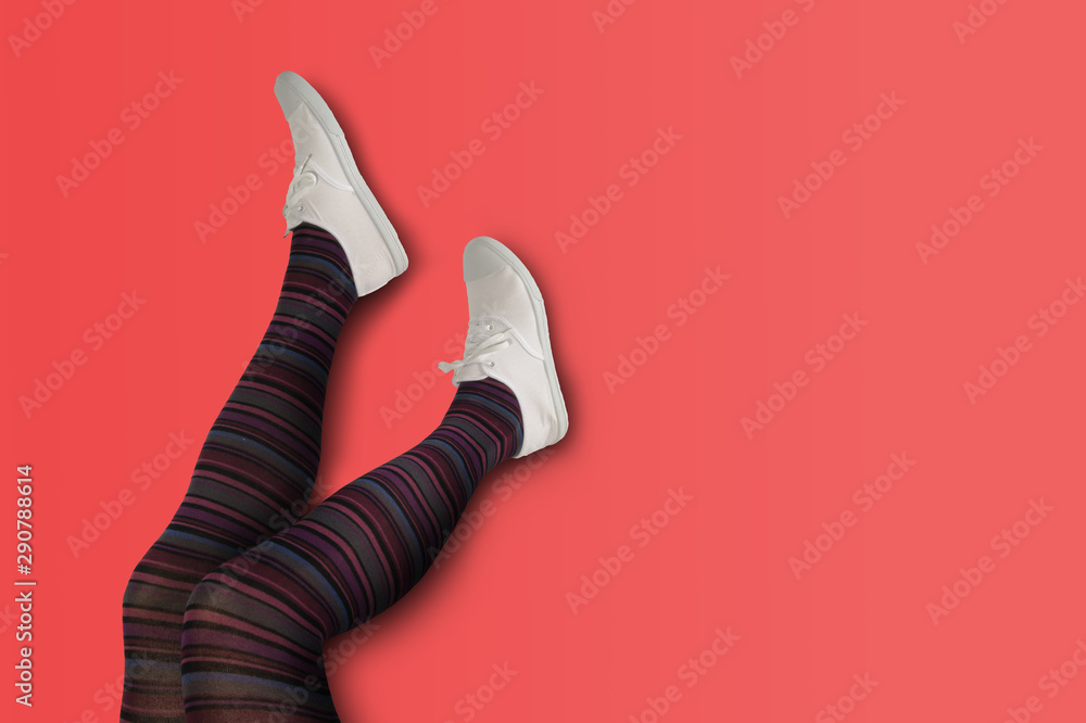 Female legs with pantyhose and sneakers. Stock Photo | Adobe Stock