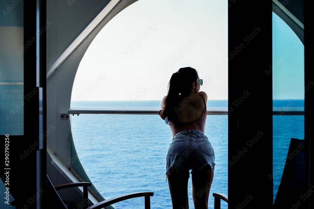 woman relaxing on Cruise ship enjoying ocean view from  balcony