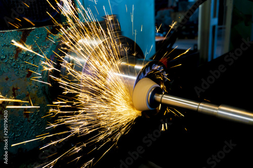 Grinding operations with an end abrasive wheel on a circular grinding machine with sparks.