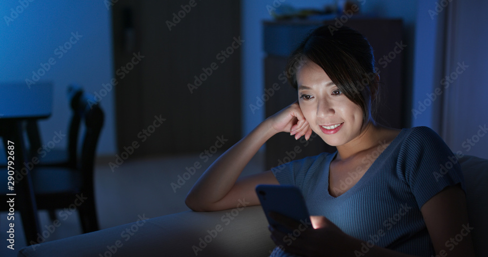 Obraz premium Woman look at mobile phone at night