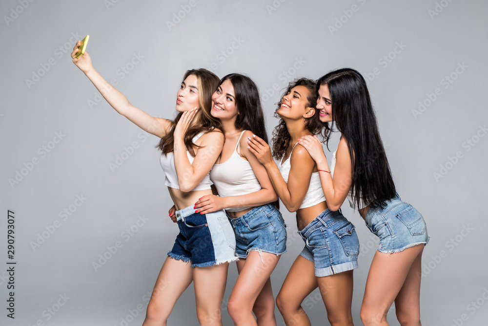 Fototapeta premium Self-portrait of four nice attractive girls best friends having fun spending holiday weekend isolated over white background