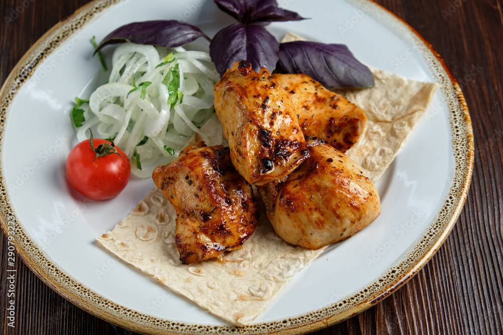 Skewers of chicken with thin pita bread . catering menu