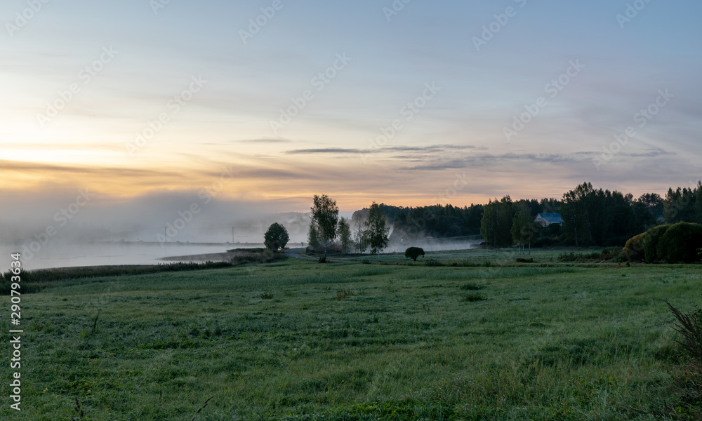 Fototapeta premium Landscape with beautiful morning mist on the lake in the distance. Forest, lake, fog. Mysterious mist