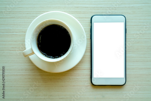  cups of coffee and smart phone on wooden table background