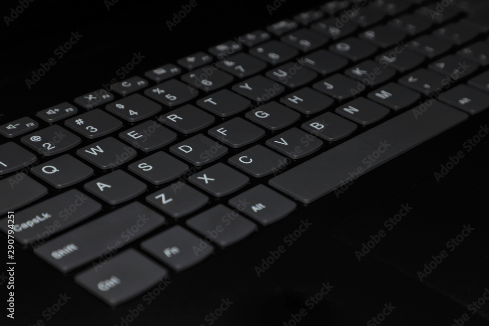 black qwerty keyboard with white latin keys closeup black qwerty keyboard with white latin keys closeup