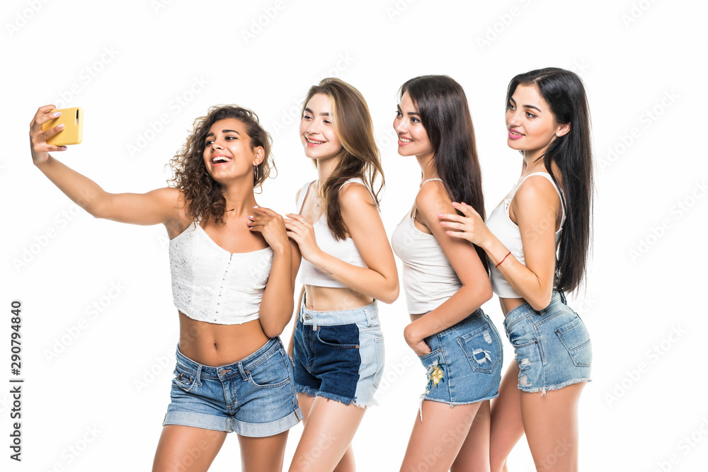 Four young girls friends taking selfie isolated on white background Four young girls friends taking selfie isolated on white background