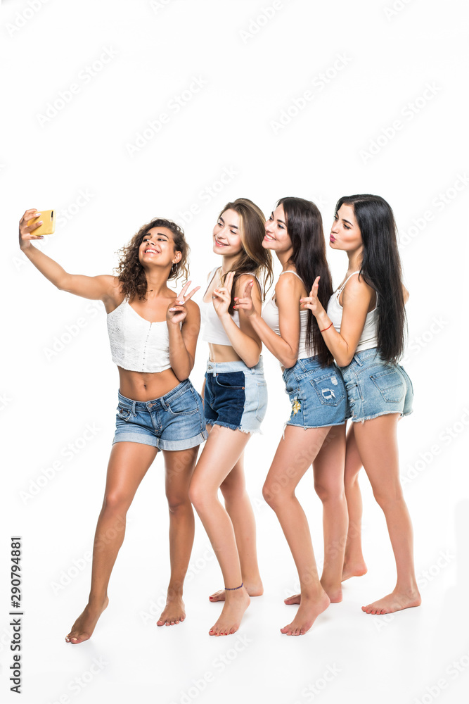 Four young girls friends taking selfie isolated on white background Four young girls friends taking selfie isolated on white background