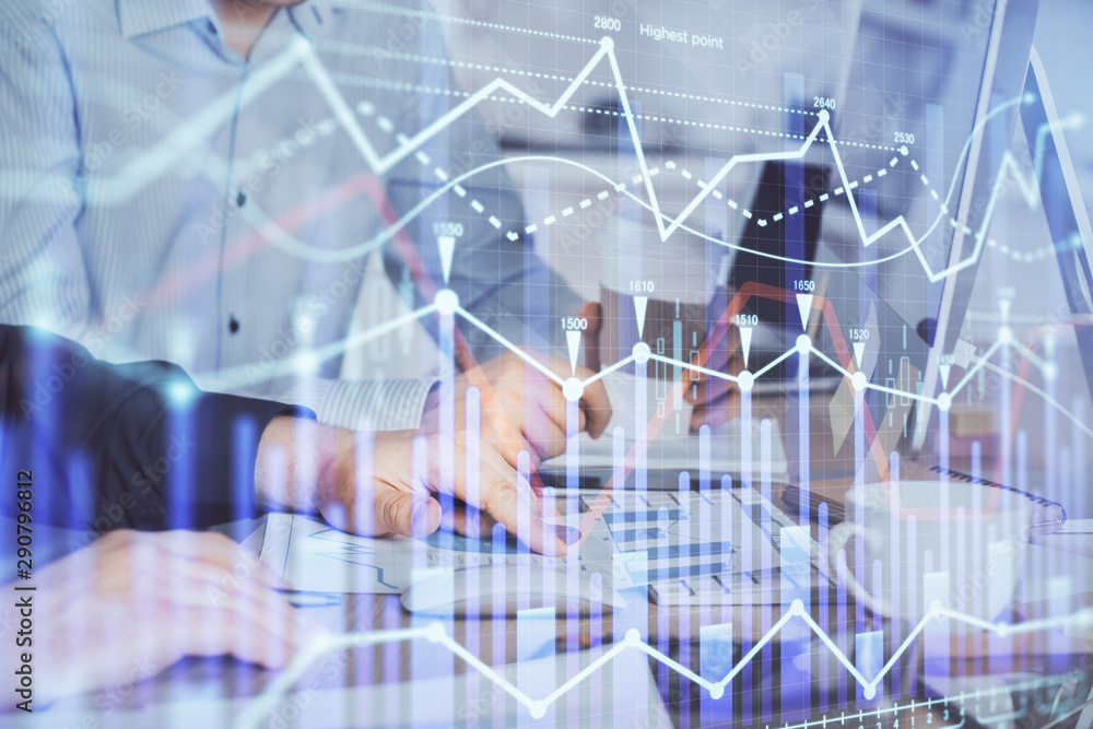Multi exposure of chart with man typing on computer in office on background. Concept of hard work. Multi exposure of chart with man typing on computer in office on background. Concept of hard work.