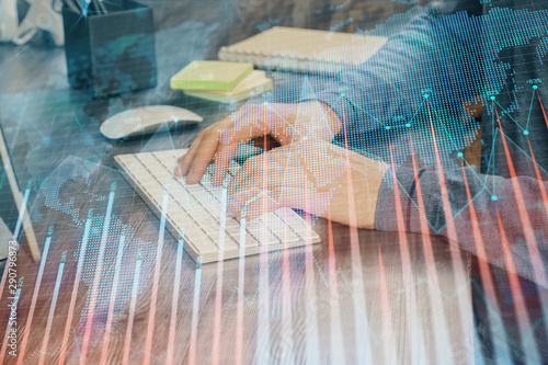 Stock graph with businessman typing on computer in office on background. Concept of analysis. Double exposure.