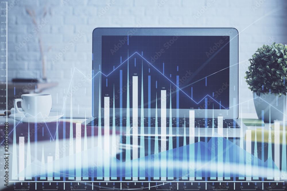Stock market chart hologram drawn on personal computer background. Multi exposure. Concept of investment. Stock market chart hologram drawn on personal computer background. Multi exposure. Concept of investment.