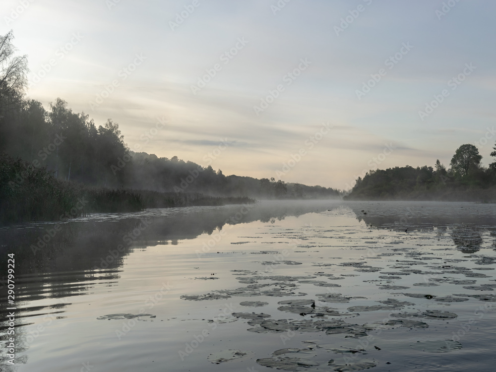 Beautiful morning fog on the lake. Forest, lake, in the fog. Mysterious fog Beautiful morning fog on the lake. Forest, lake, in the fog. Mysterious fog
