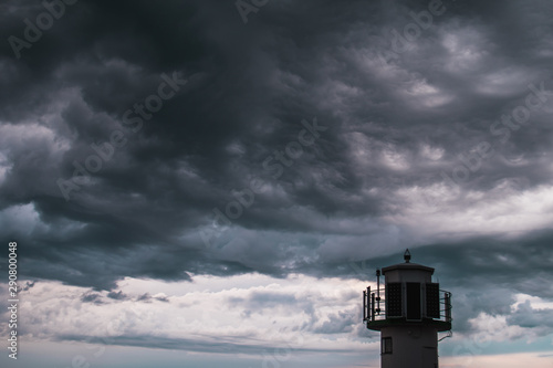 A lighthouse infront of stormy clouds