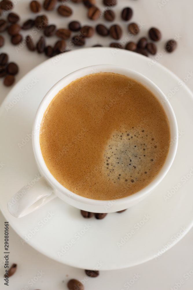 white cup with black coffee and coffee beans top view white cup with black coffee and coffee beans top view