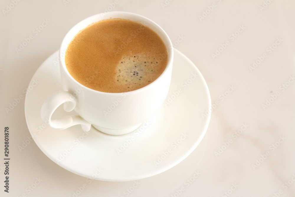 white cup with black coffee on a marble background white cup with black coffee on a marble background