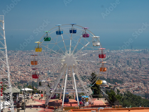 Spain, may 2019: Scenic view of Barcelona city with colourful ferris wheel from Tibidabo