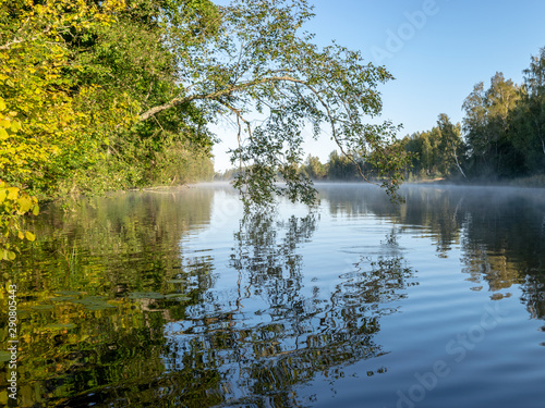 beautiful landscape with lake, early morning, lake fog, morning sun colored trees