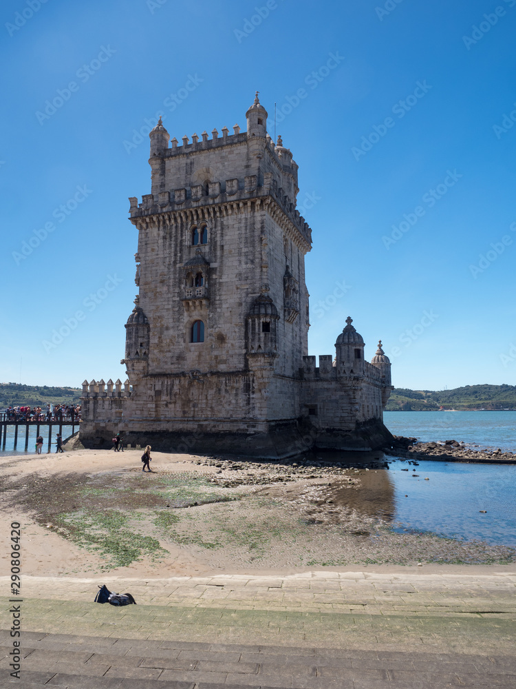 Portugal, may 2019: Scenic Belem Tower and wooden bridge miroring with low tides on Tagus River. Torre de Belem is Unesco Heritage and icon of Lisbon and the most visited attraction in Lisbon