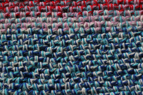 Crochet fabric background in blue, pink, and red
